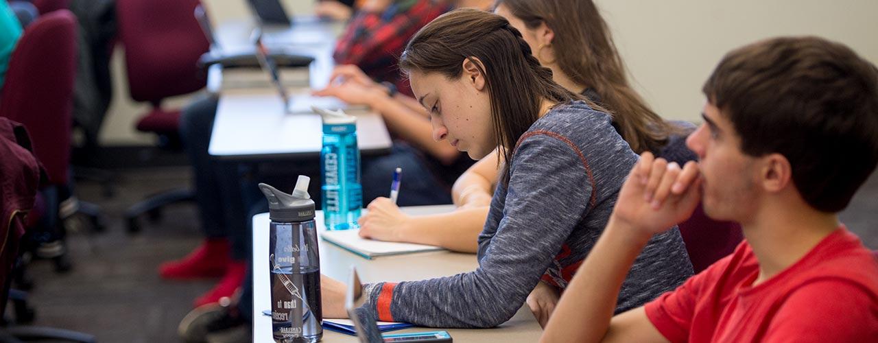 Male and female students listening in class